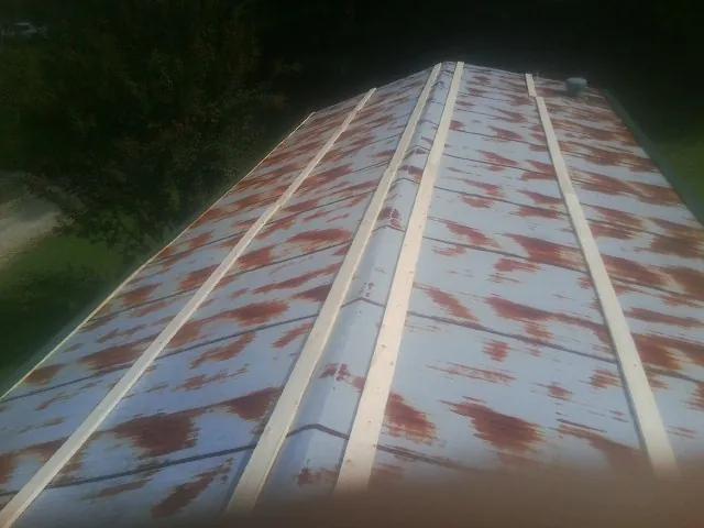 Rusted metal roof panels with new wood purlins before replacement — Storm Damage Roof Repair in Eminence by Roofing Brothers